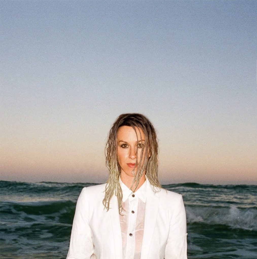 Alanis Morissette standing in front of the ocean