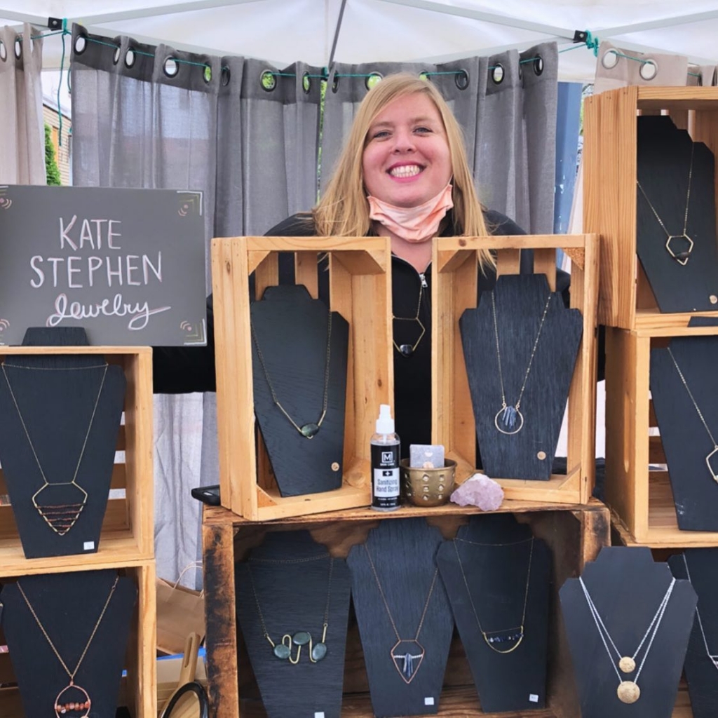 Kate Stephen selling her jewlery at a table at a pop-up event or market.