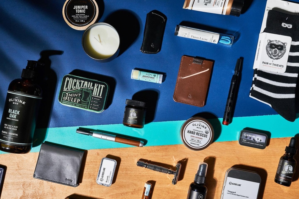 An overlay shot of mens lifestyle products such as wallets, shaving items, and socks.