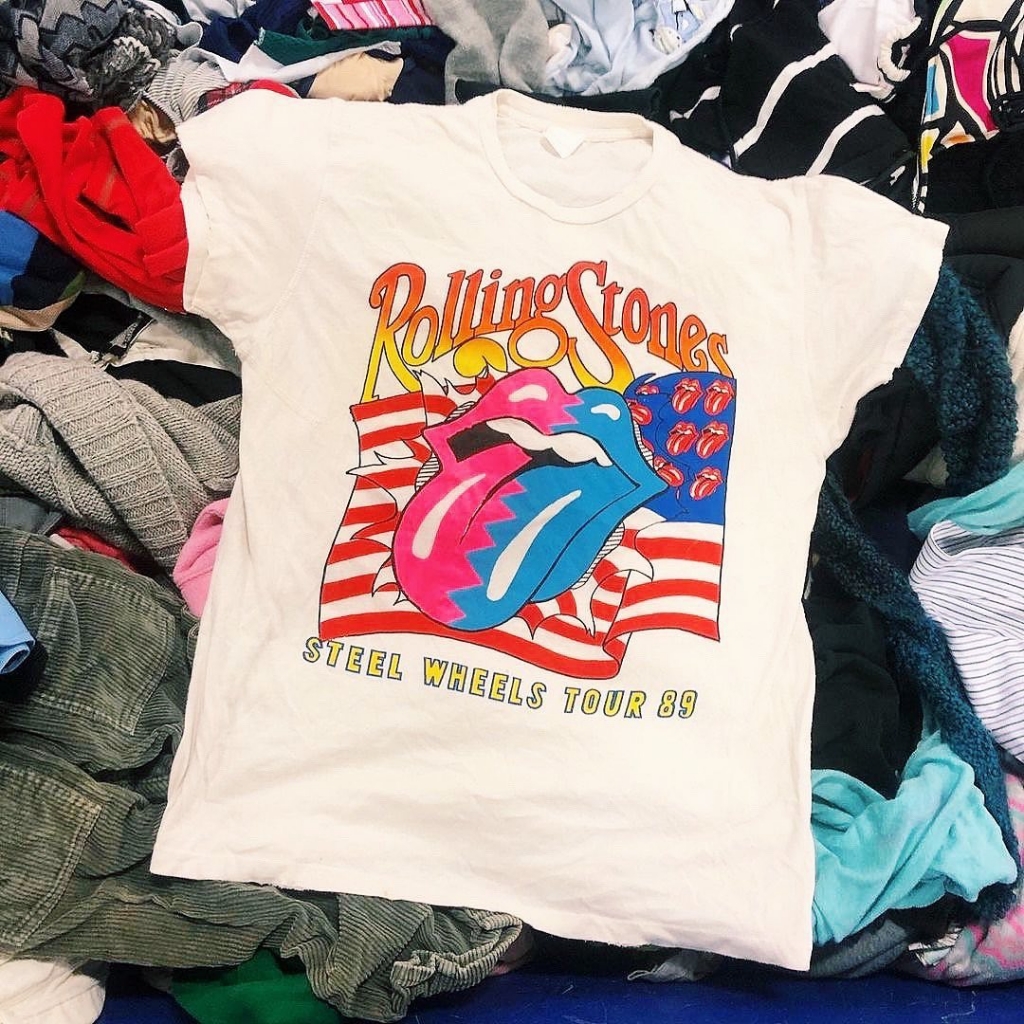 Rolling Stones band tee on a pile of t shirts.