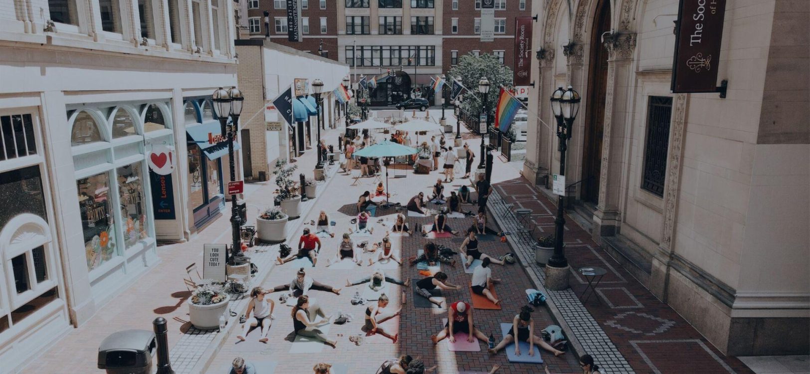 Aerial shot of people doing yoga on the Pratt Street Patio with a sepia filter